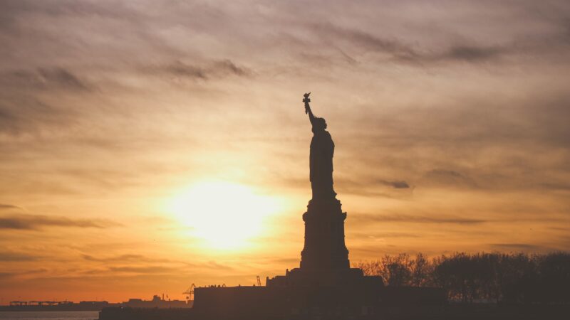 Statue of Liberty at silhouetted in the sunset
