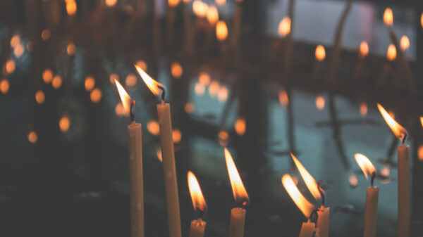 white candles flickering in the wind