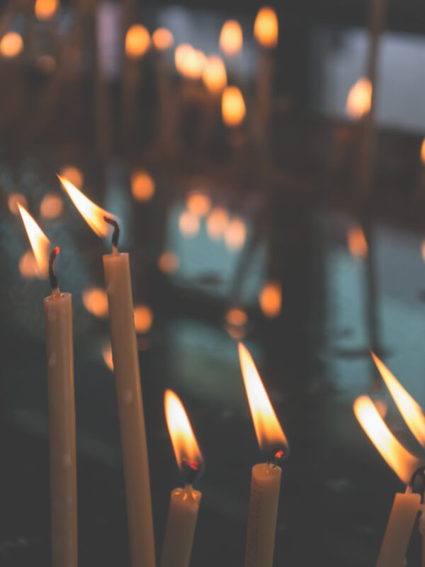 white candles flickering in the wind