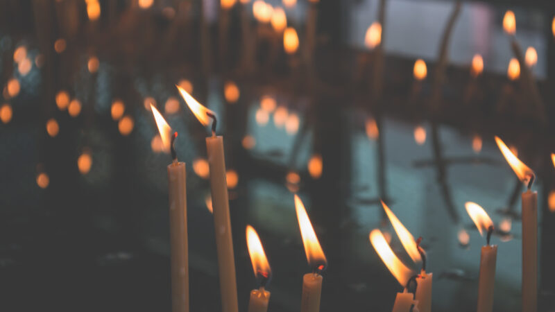 white candles flickering in the wind
