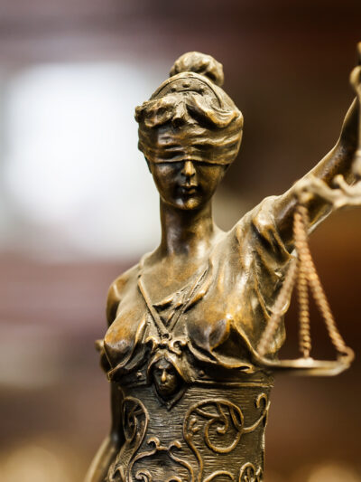 statue of blindfolded woman holding scales of justice