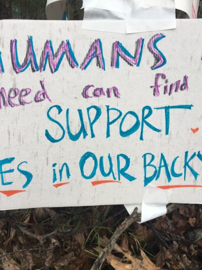 sign reads: Humans in need can find support...yes, in our backyard