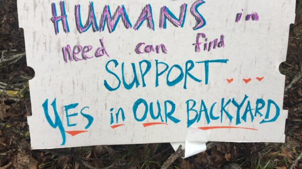 sign reads: Humans in need can find support...yes, in our backyard