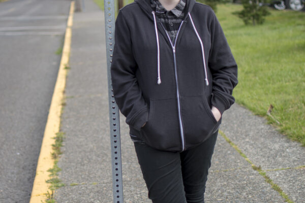 Hailey leans against a street sign