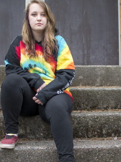 Liv Funk sits on the steps of North Bend High School