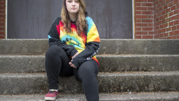 Liv Funk sits on the steps of North Bend High School