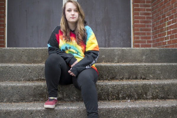 Liv Funk sits on the steps of North Bend High School
