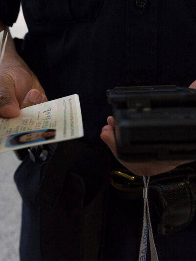 A CBP officer scanning a passport