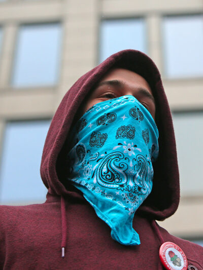 A demonstrator wearing a bandana on their face