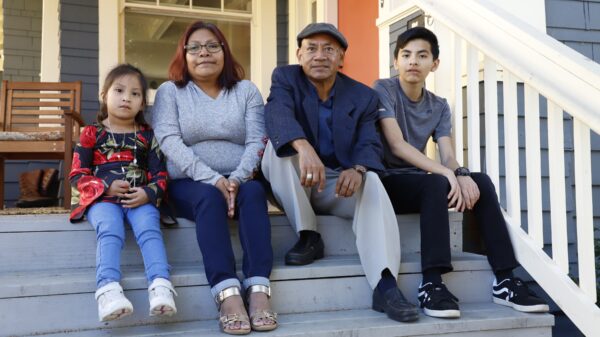 family on front steps of home