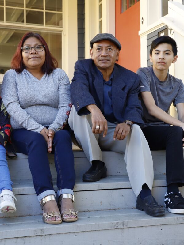 family on front steps of home