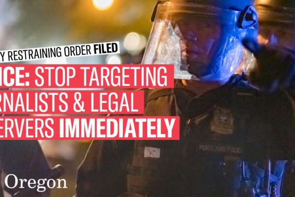 police officers in riot gear with banners reading: Temporary Restraining Order Filed; Police Stop Targeting Journalists and Legal Observers Immediately