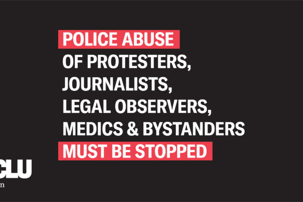 banner that reads, "Police abuse of protesters, journalists, legal observers, medics & bystanders must be stopped."
