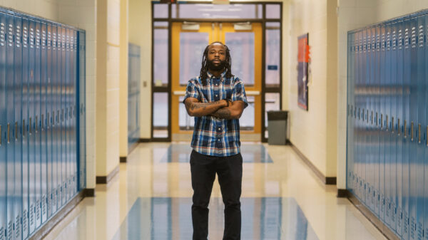 Anthony, a teacher profiled in this blog, stands in the middle of his school's hallway