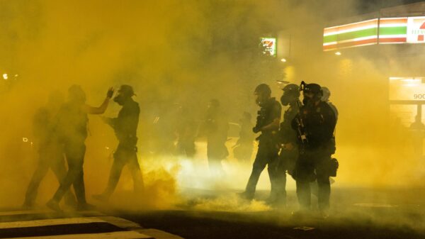 Image of tear gas filling up a street.