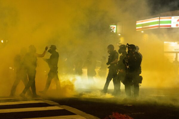 Image of tear gas filling up a street.