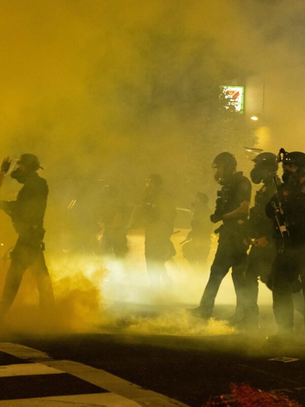 Image of tear gas filling up a street.