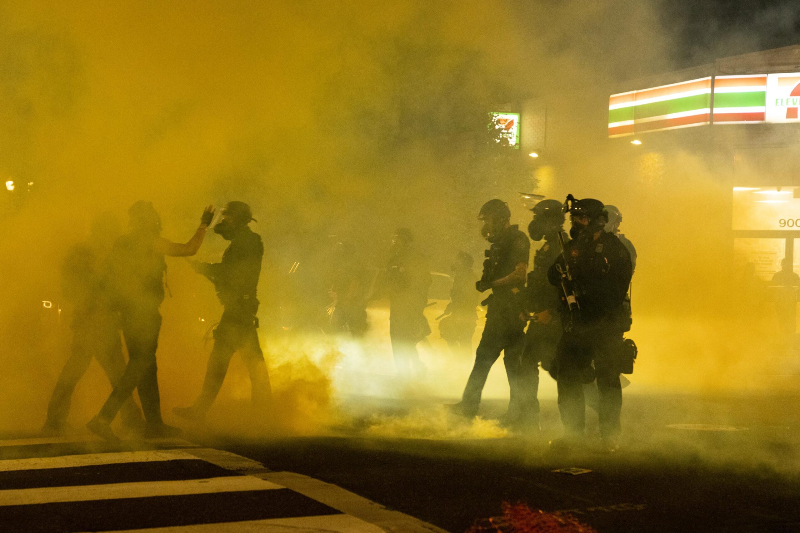 Image of tear gas filling up a street.