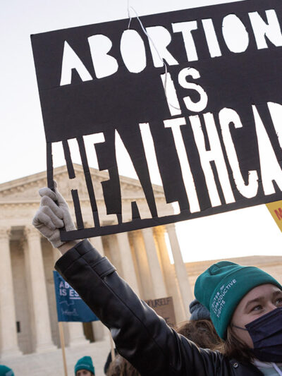 A person at a rally holding a sign that says “Abortion is Healthcare.”