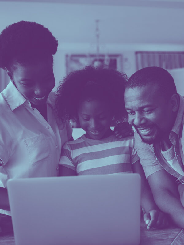 image of family grouped around a laptop