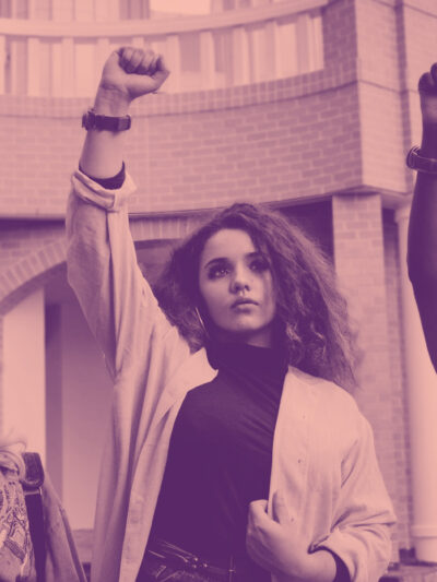 people in protest raising fists on pink background
