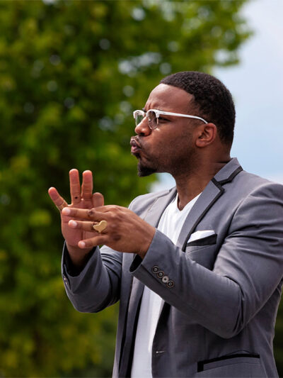 An American Sign Language interpreter interpreting at an anti-racism rally and march.