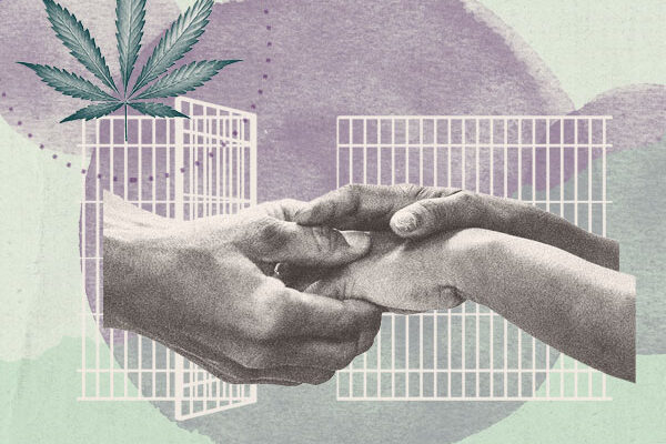 Hands clasped in front of open prison doors