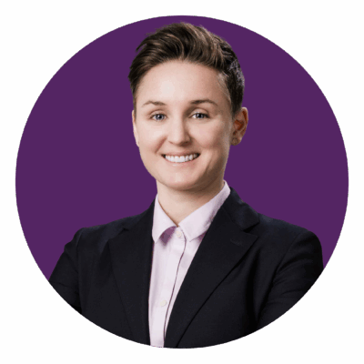 photo of Kelly smiling in front of purple background