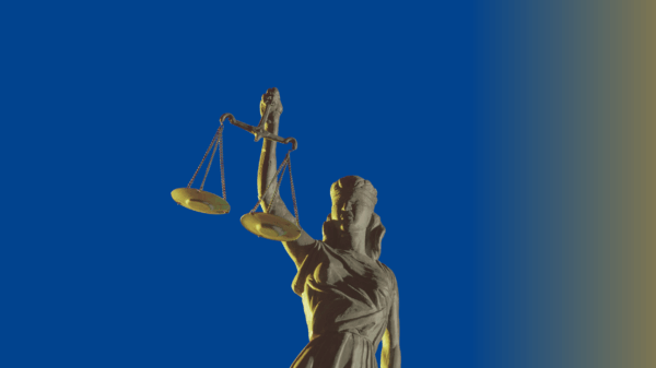 Blue background with an image of the lady of justice statue in the center.