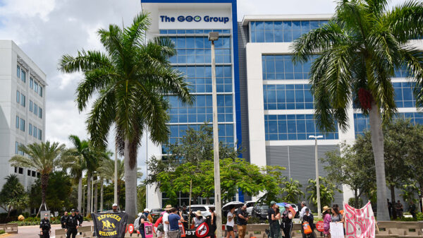 Protestors march in front of the ICE Company, The Geo Group building, demanding the end of private prisons.