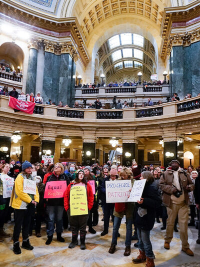 Pro-choice protesters holding signs in the Wisconsin capitol.