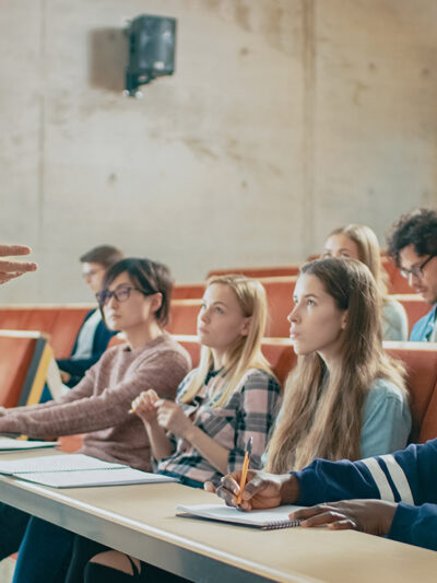 A professor holding a lecture to a group of students.
