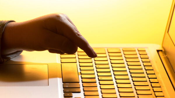 A finger pressign a keyboard.