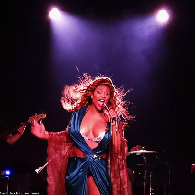 a photo of Peppermint, ACLU Trans Justice Ambassador, singing into a mic