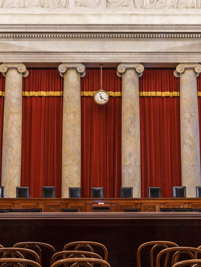 The vacant interior of the US Supreme Court with the justices' equally vacant seats.