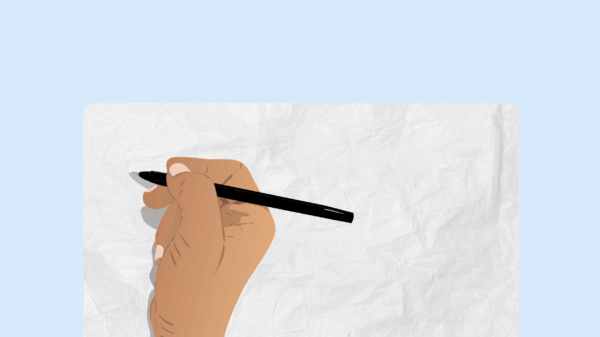 blue background with a sheet of paper on top and a hand holding a black pen.