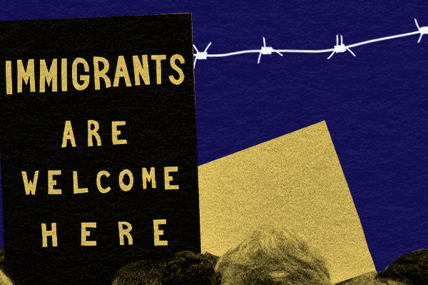Protests signs reading Immigrants Are Welcome Here with barbed wire in the background