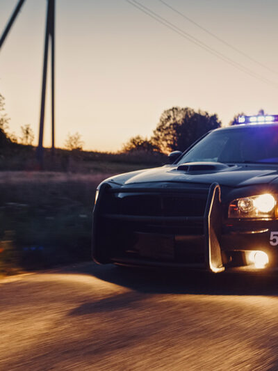 A police crd speeding down the road.
