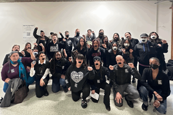 Group of advocates with black tape covering their mouths to symbolize not being heard by lawmakers