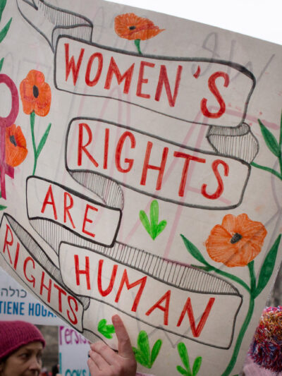 Someone holding a sign that says Women's Rights Are Human Rights.