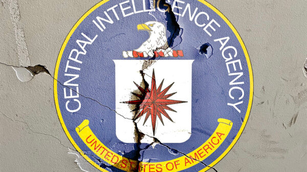 CIA logo on cracked wall.
