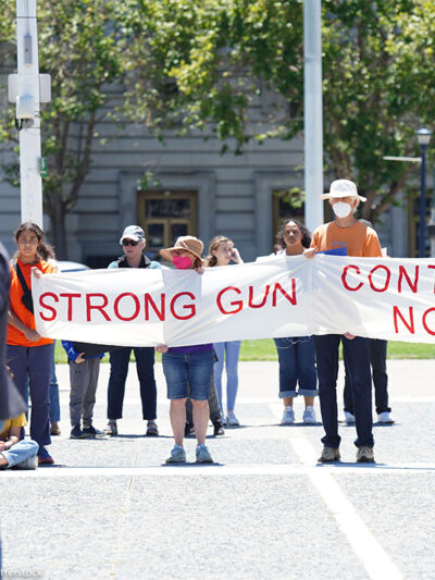 Protesters hold a banner that says "Strong gun control now" during an anti-gun violence rally in San Francisco rally.