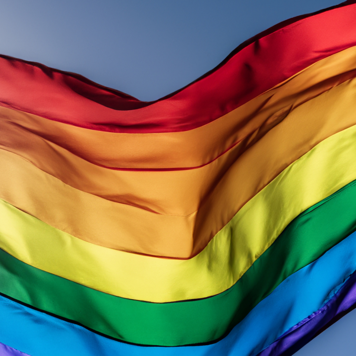 A rippling rainbow flag in the sky.