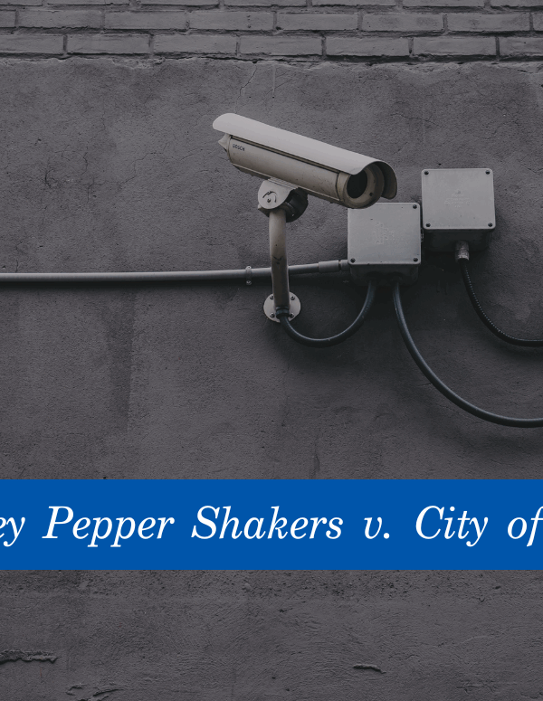 Image of white security cameras against a grey wall. At the bottom is a blue banner with the text, Rogue Valley Pepper Shakers v. City of Medford."