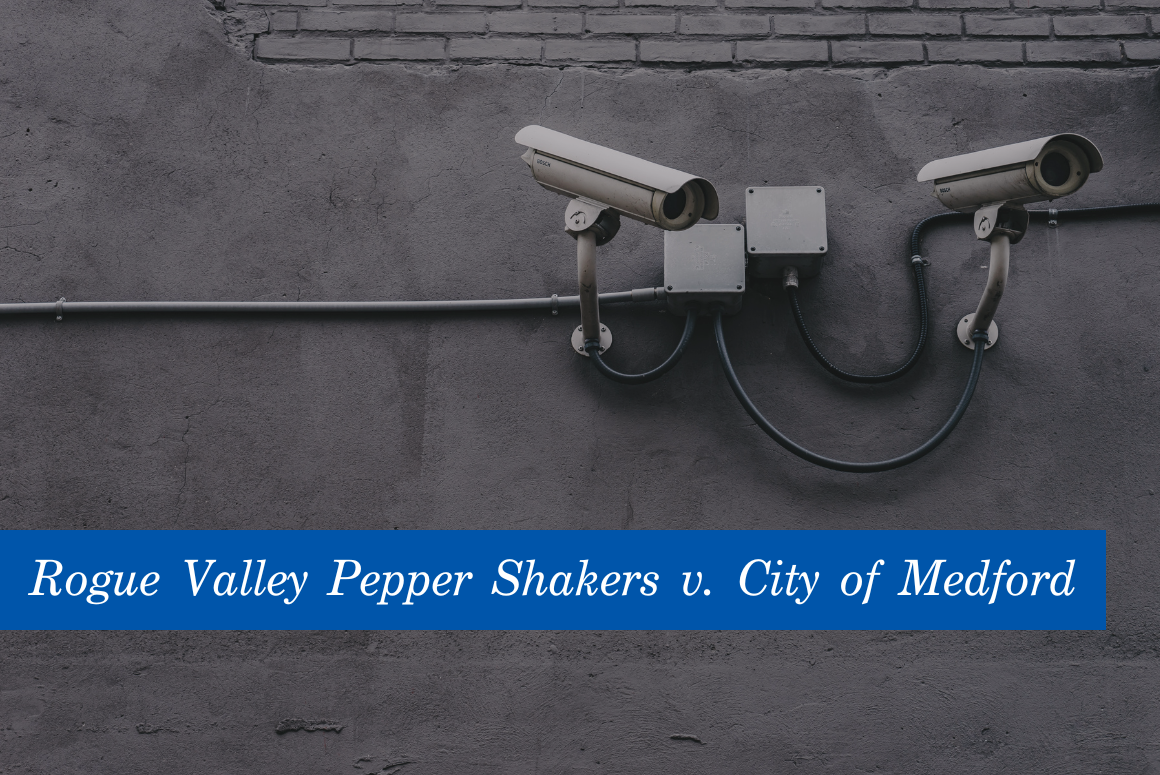 Image of white security cameras against a grey wall. At the bottom is a blue banner with the text, Rogue Valley Pepper Shakers v. City of Medford."