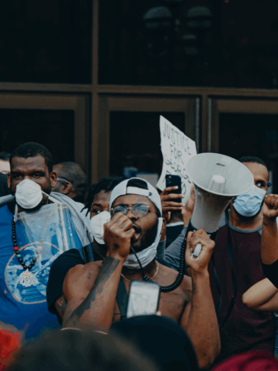groups of protesters in front of glass doors.