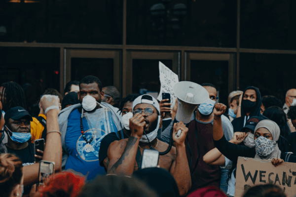 groups of protesters in front of glass doors.