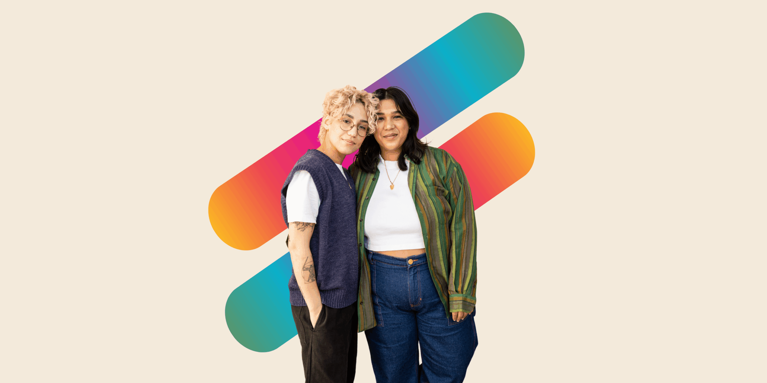 A queer appearing couple with their arms around each other in front of two thick lines with a rainbow color gradient.