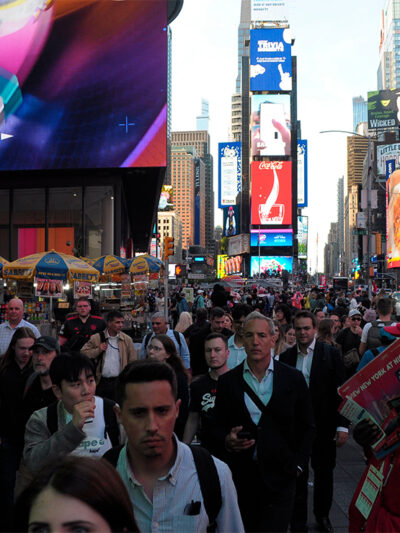 Pedestrians walking through Times Square.