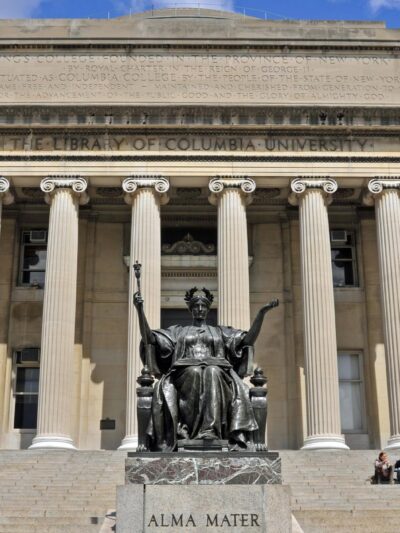 Facade of the Columbia University Library with the ALMA MATER statue in the foreground.
